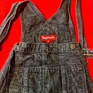 Supreme men’s size med overalls. Print is $100 bills